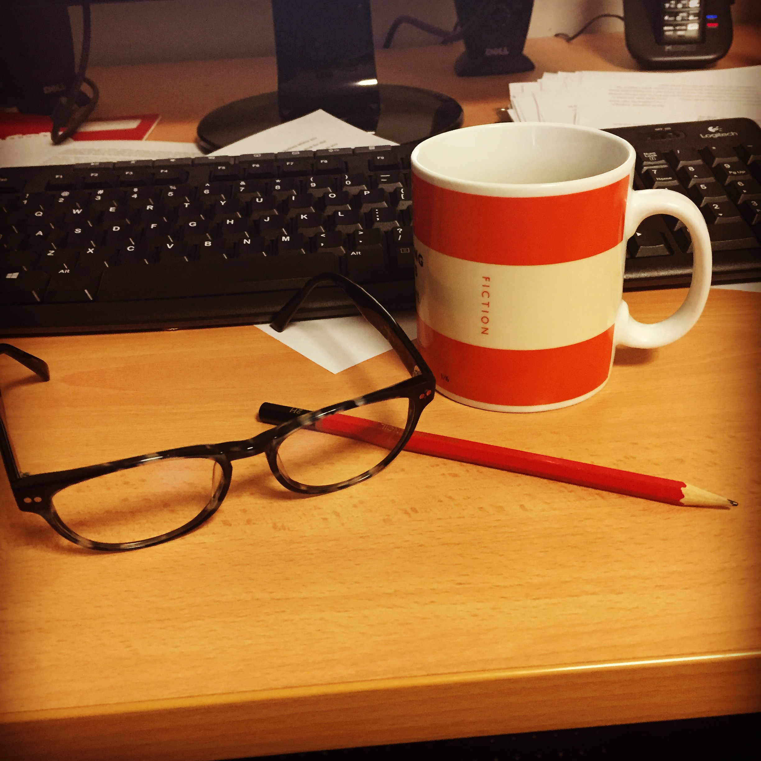 Keyboard , glasses pencil and coffee mug.